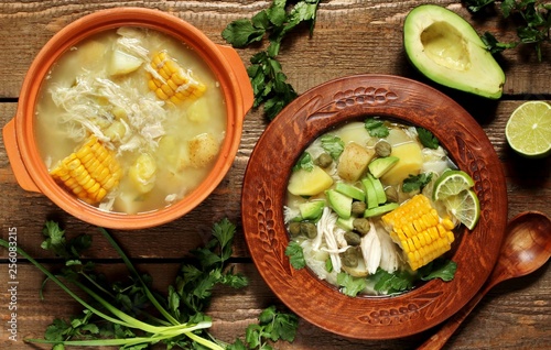 chicken soup with potatoes. Colombian cuisine. in spanish it sounds like "Ajiaco".  Latin American cuisine. served with avocado, capers, lime, cilantro. saturated rich homemade soup.