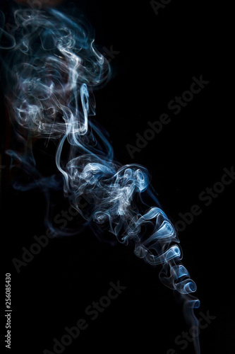 Close-up abstract beautiful smoke on a black isolated background. Blur and soft focus.