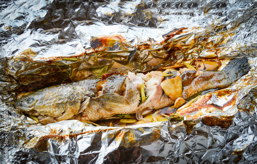 striped snakehead fish cooking grilled with salt sauce and herb on foil food