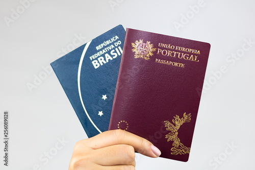 Hand holding Brazilian passport (Translation 