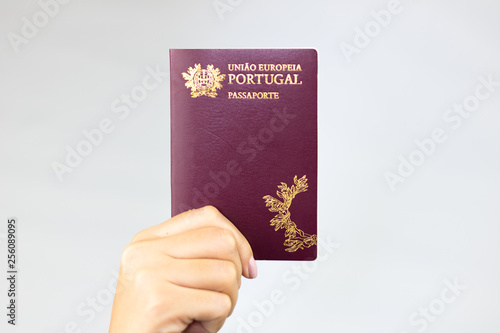 Hand holding  portuguese passport (Translation 