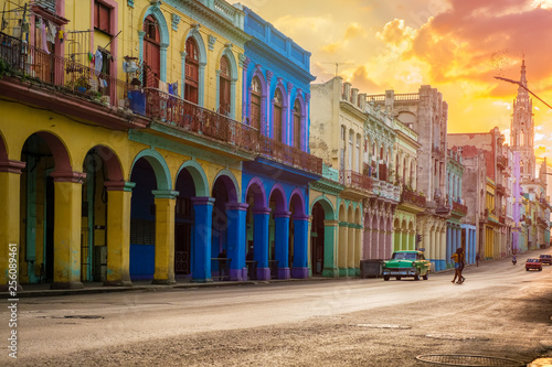 Classic car and colorful buildings  in Havana at sunset © kmiragaya