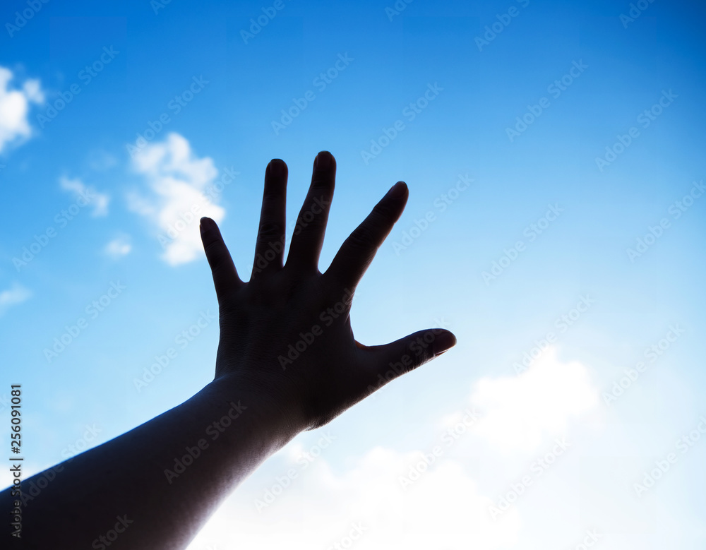 The silhouette hand sign reach to the sky background,show five fingers The silhouette hand sign reach to the sky background,show five fingers