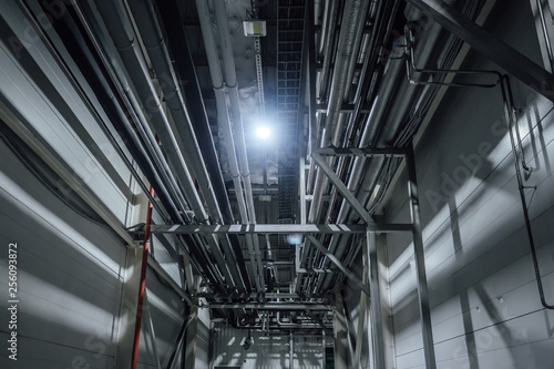 Heating or cooling water pipes on ceiling of industrial or office building