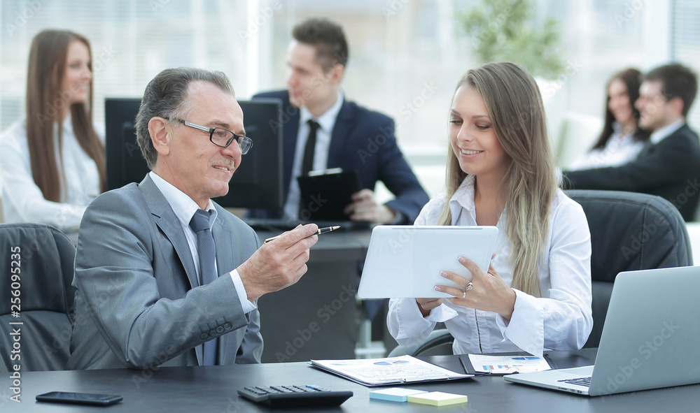 employees using digital tablet to work with financial data employees using digital tablet to work with financial data