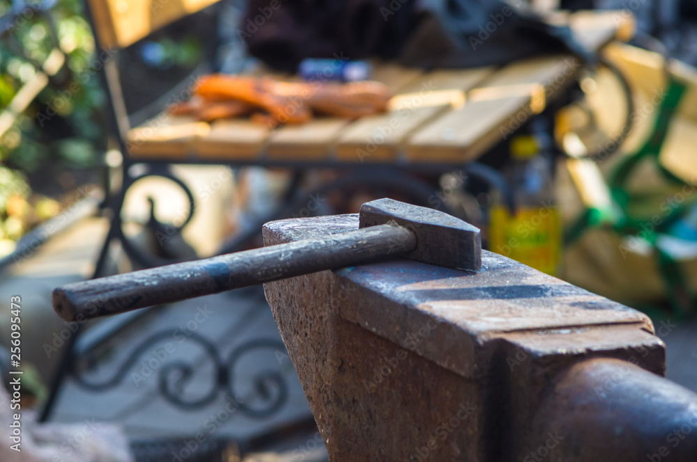 blacksmith performs the forging of hot glowing metal on the anvil blacksmith performs the forging of hot glowing metal on the anvil
