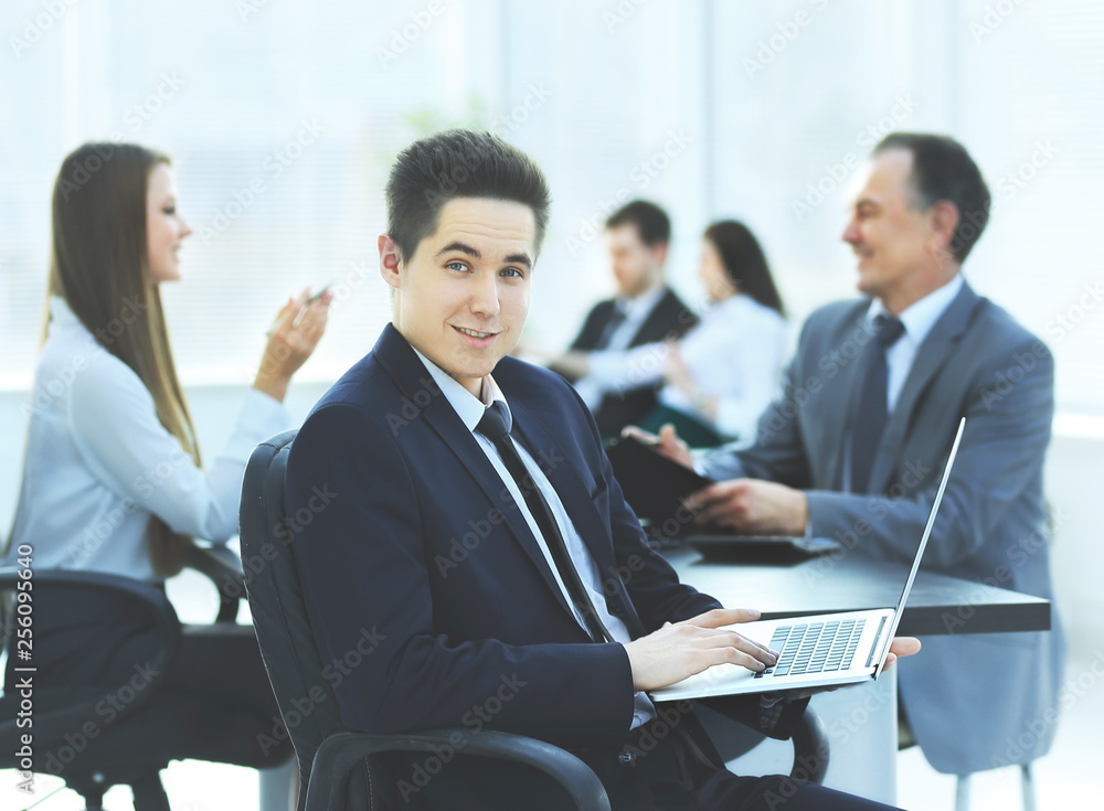 Portrait of handsome young business man and laptop Portrait of handsome young business man and laptop