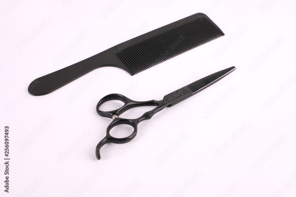 Barber scissors and a hairbrush isolated on white background Barber scissors and a hairbrush isolated on white background