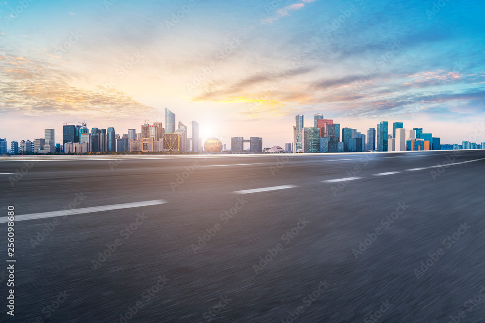 Foreground highway asphalt pavement city building commercial building office building Foreground highway asphalt pavement city building commercial building office building