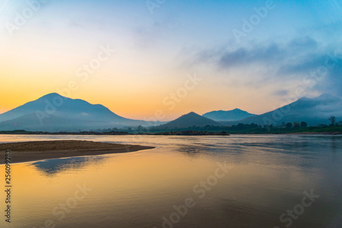 Mountain river beach beautiful with colorful blue and yellow sky sunrise or sunset © Bigc Studio