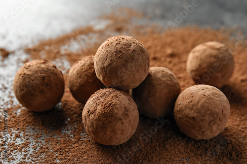 Delicious raw chocolate truffles on grey background