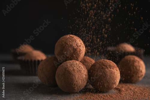 Tasty chocolate truffles powdered with cocoa on table photo