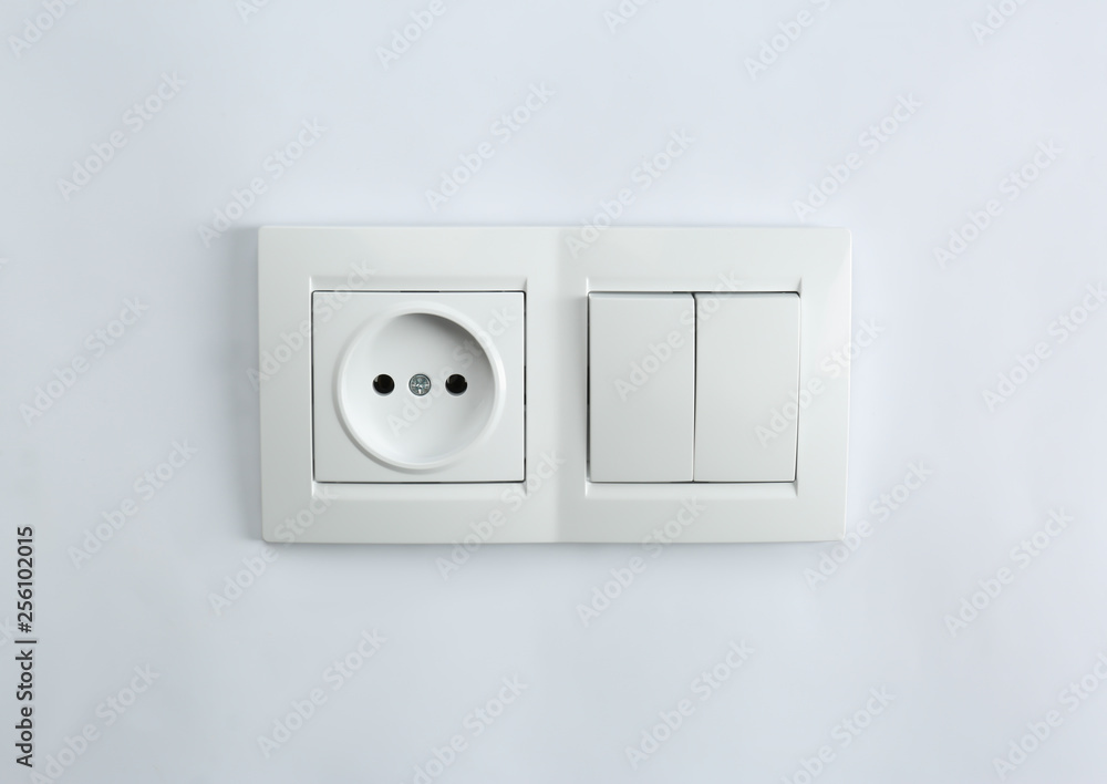 Light switch and power socket on white background. Electrician's equipment Light switch and power socket on white background. Electrician's equipment