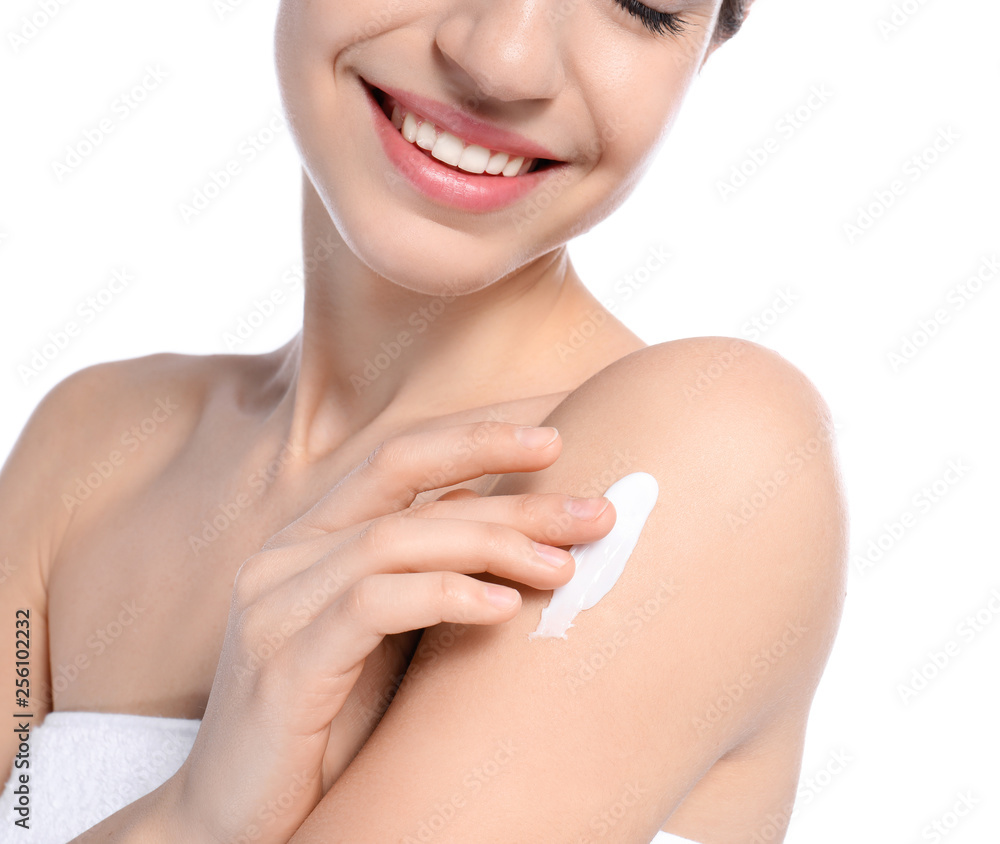 Young woman applying cream on white background, closeup. Beauty and body care Young woman applying cream on white background, closeup. Beauty and body care
