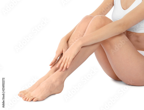 Young woman with perfect smooth skin on white background  closeup of legs. Beauty and body care