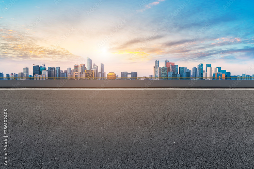 Foreground highway asphalt pavement city building commercial building office building Foreground highway asphalt pavement city building commercial building office building