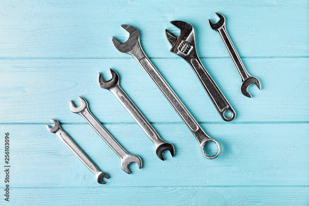 New wrenches on color background, top view. Plumber tools New wrenches on color background, top view. Plumber tools