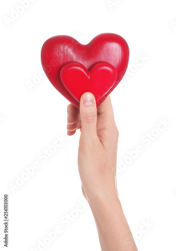 Woman holding decorative hearts in hand on white background, closeup
