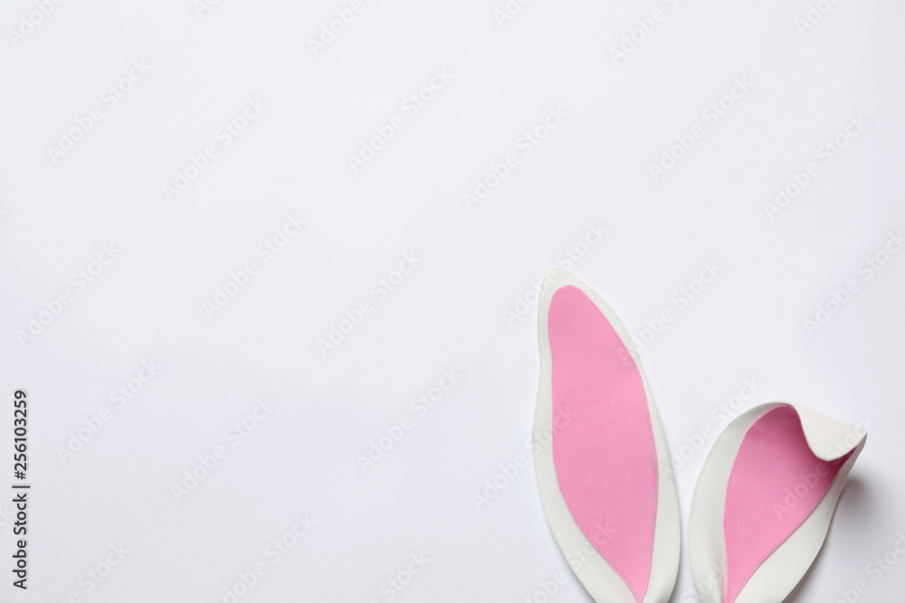 Funny Easter bunny ears on white background, top view