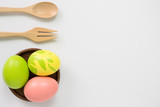 color eggs and fork, spoon for easter on white background