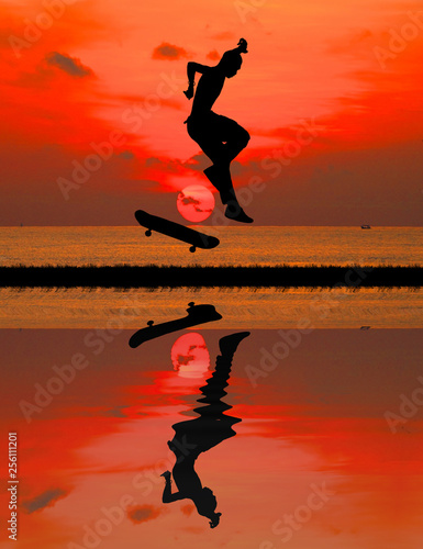 silhouette of skateboarder on blurry sunrise background.