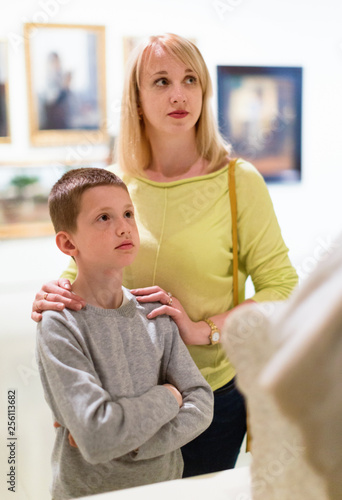 Mother and son looking at expositions in museum