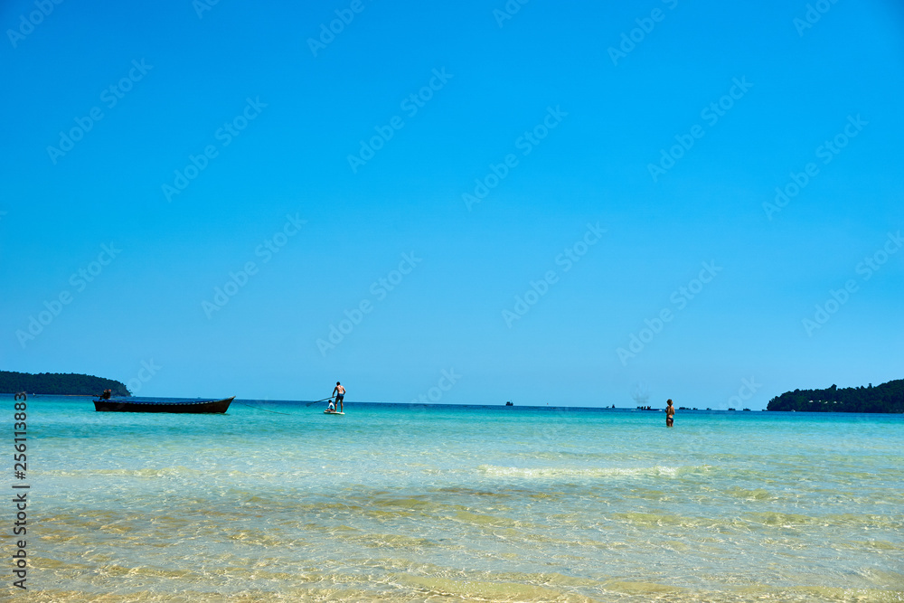Stand up paddling at beach at nice sunny summer day. Koh Rong Sanloem island, Saracen Bay. Cambodia, Asia