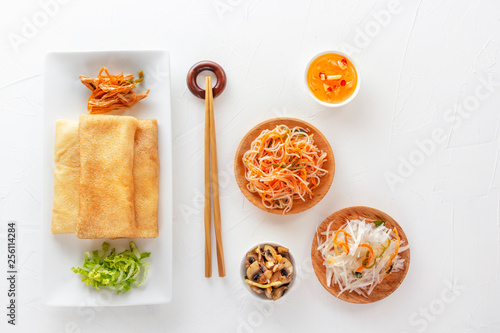 Wallpaper Mural Traditional snacks of Chinese cuisine Dim Sum - tortillas - bings in a plate on a white background, spicy salads, vegetables, noodles. View from above. Torontodigital.ca