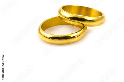 Close up of two gold rings for wedding isolated on white
