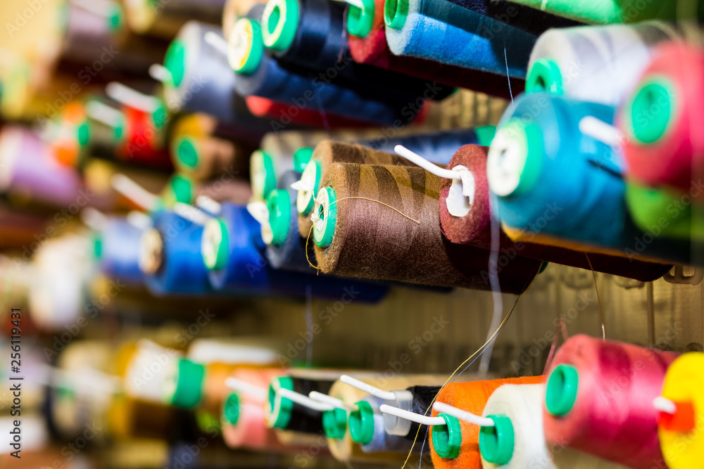 Close Up Of Colorful Sewing Threads In Drawer. Closeup Shot Of Multicolored Spools Of Thread, Sewing Accessories In Atelier.Selective focus.Sewing tools and sewing supplies,accessories