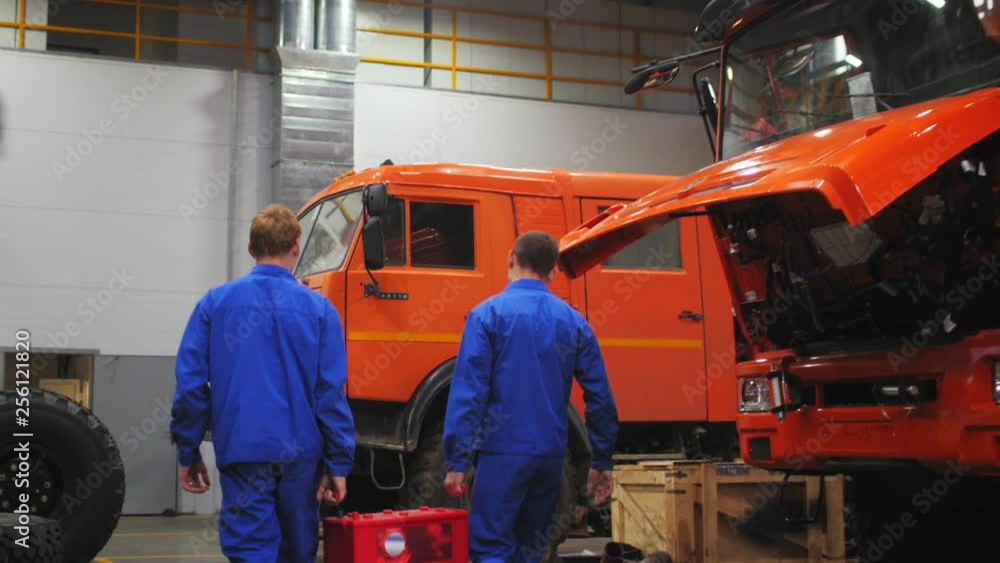men with accumulator battery in repair shop slow motion men with accumulator battery in repair shop slow motion