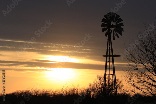 Kansas Windmill Silhouette with clouds at Sunset.