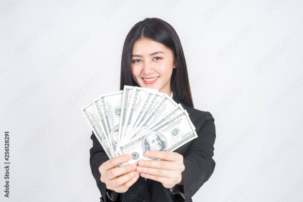 Successful beautiful Asian business young woman holding money US dollar bills in hand , business concept Successful beautiful Asian business young woman holding money US dollar bills in hand , business concept