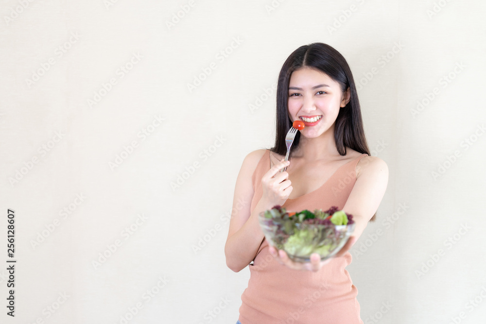 Beautiful beauty woman Asian cute girl feel happy eating diet food fresh salad for good health in the morning , enjoying time in her home white bedroom background - lifestyle beauty woman concept Beautiful beauty woman Asian cute girl feel happy eating diet food fresh salad for good health in the morning , enjoying time in her home white bedroom background - lifestyle beauty woman concept