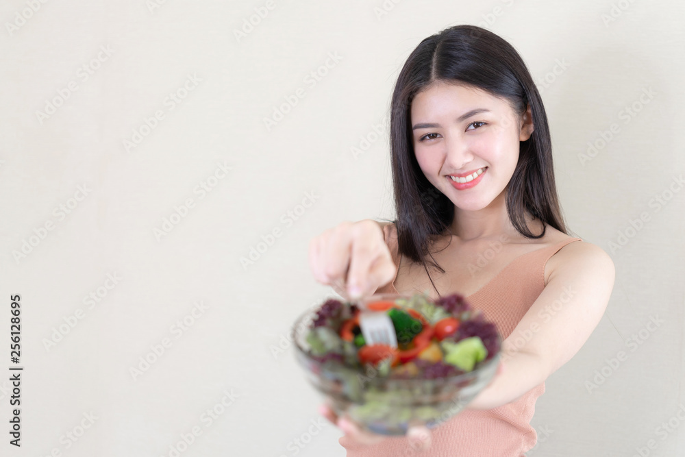 Beautiful beauty woman Asian cute girl feel happy eating diet food fresh salad for good health in the morning , enjoying time in her home white bedroom background - lifestyle beauty woman concept Beautiful beauty woman Asian cute girl feel happy eating diet food fresh salad for good health in the morning , enjoying time in her home white bedroom background - lifestyle beauty woman concept