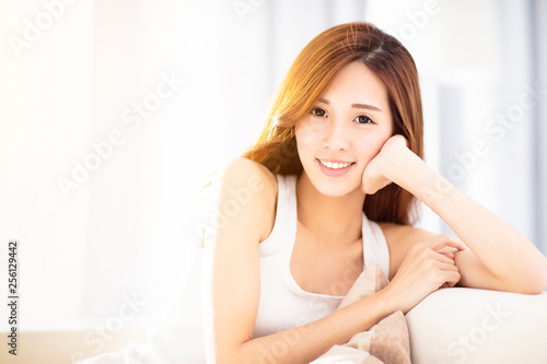 Young beautiful relaxed woman sitting on sofa