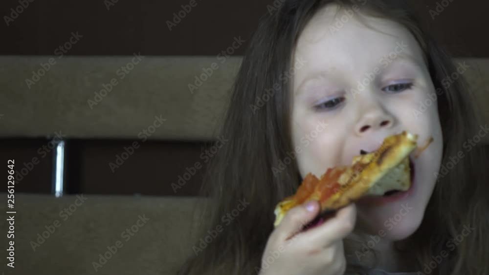 Little girl eating pizza at home Little girl eating pizza at home