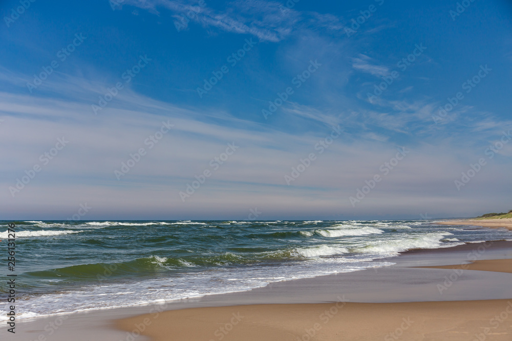 Sandy coast and waves from the Baltic Sea on the Curonian Spit, Russia