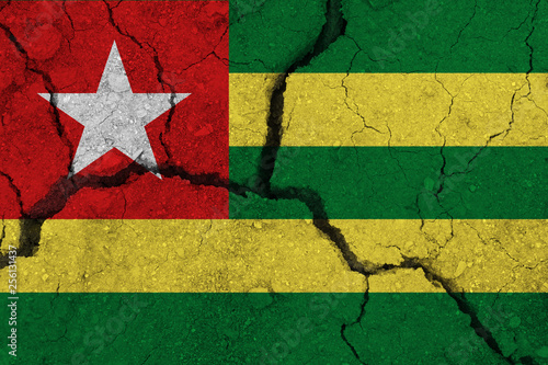 Togo flag on the cracked earth