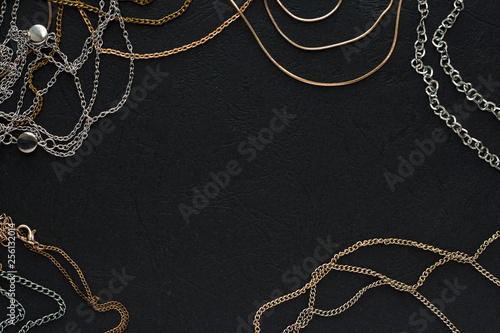 Beautiful shiny jewelry on a black background, minimalism.Flat lay, top view, copy place