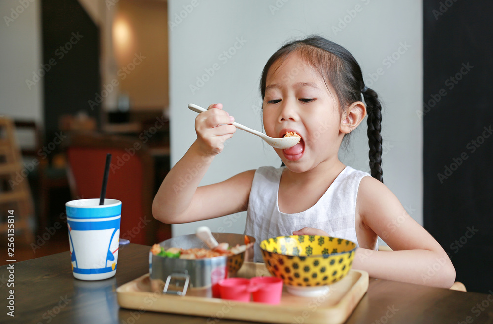 Portrait of little Asian child girl having breakfast at the morning. Portrait of little Asian child girl having breakfast at the morning.