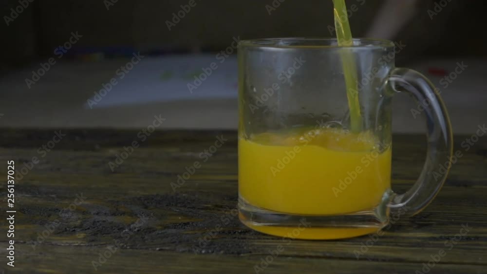 Pouring Orange Juice Into Glass Cup. Slow motion footage Pouring Orange Juice Into Glass Cup. Slow motion footage