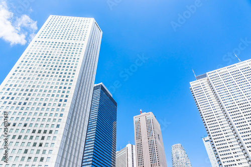 Asia Business concept for real estate and corporate construction - looking up view of panoramic modern city skyline with blue sky in shinjuku, tokyo, japan