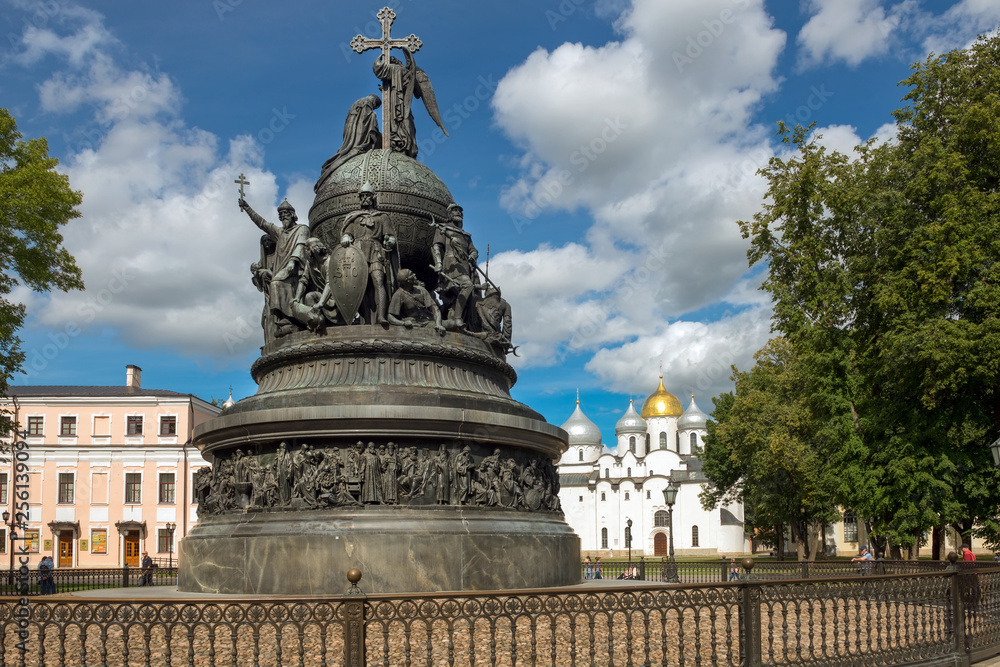 VELIKY NOVGOROD, RUSSIA - AUGUST 14, 2018: Monument Millenium of Russia on the background of St. Sophia Cathedral with tourists walking along in summer day