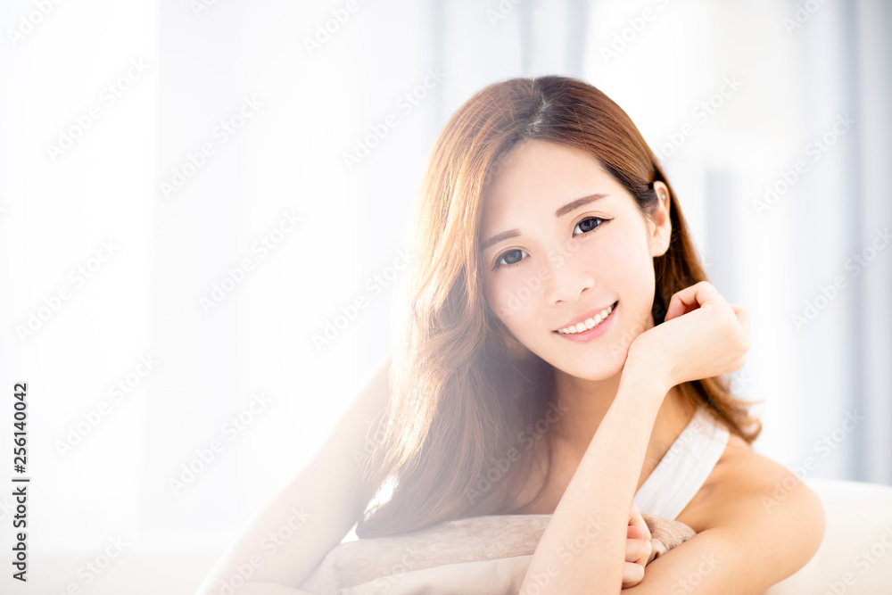 Young beautiful relaxed woman sitting on sofa Young beautiful relaxed woman sitting on sofa