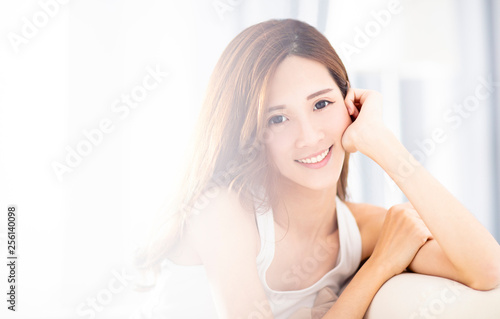 Young beautiful relaxed woman sitting on sofa © Tom Wang