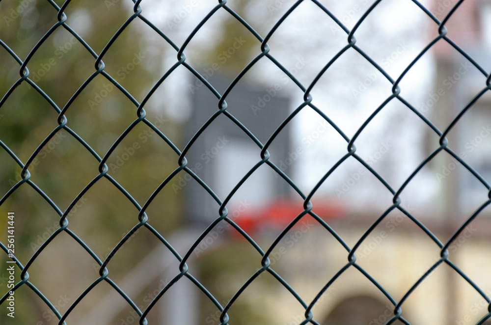 Basketball backboard behind steel fence net Basketball backboard behind steel fence net