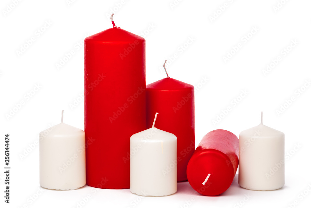 Red and white colored xmas candles isolated on white background Red and white colored xmas candles isolated on white background