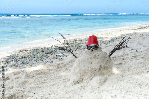 Snowman made of white sand instead of snow.