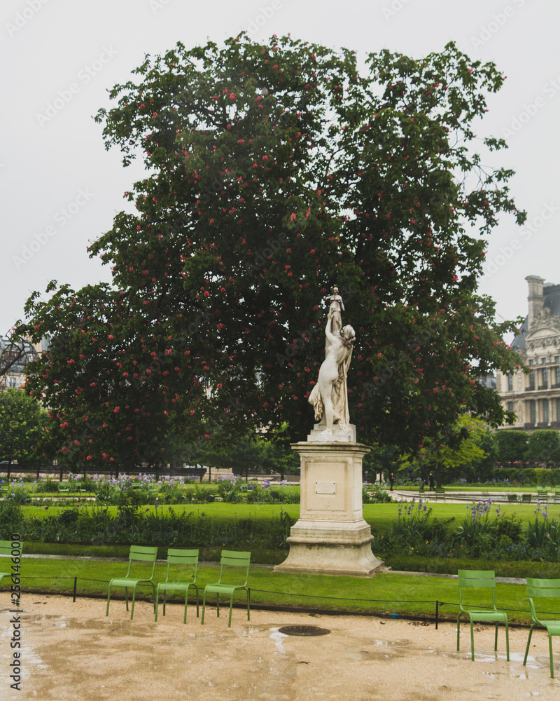 Statue and trees in Tuileries Garden, in Paris, France